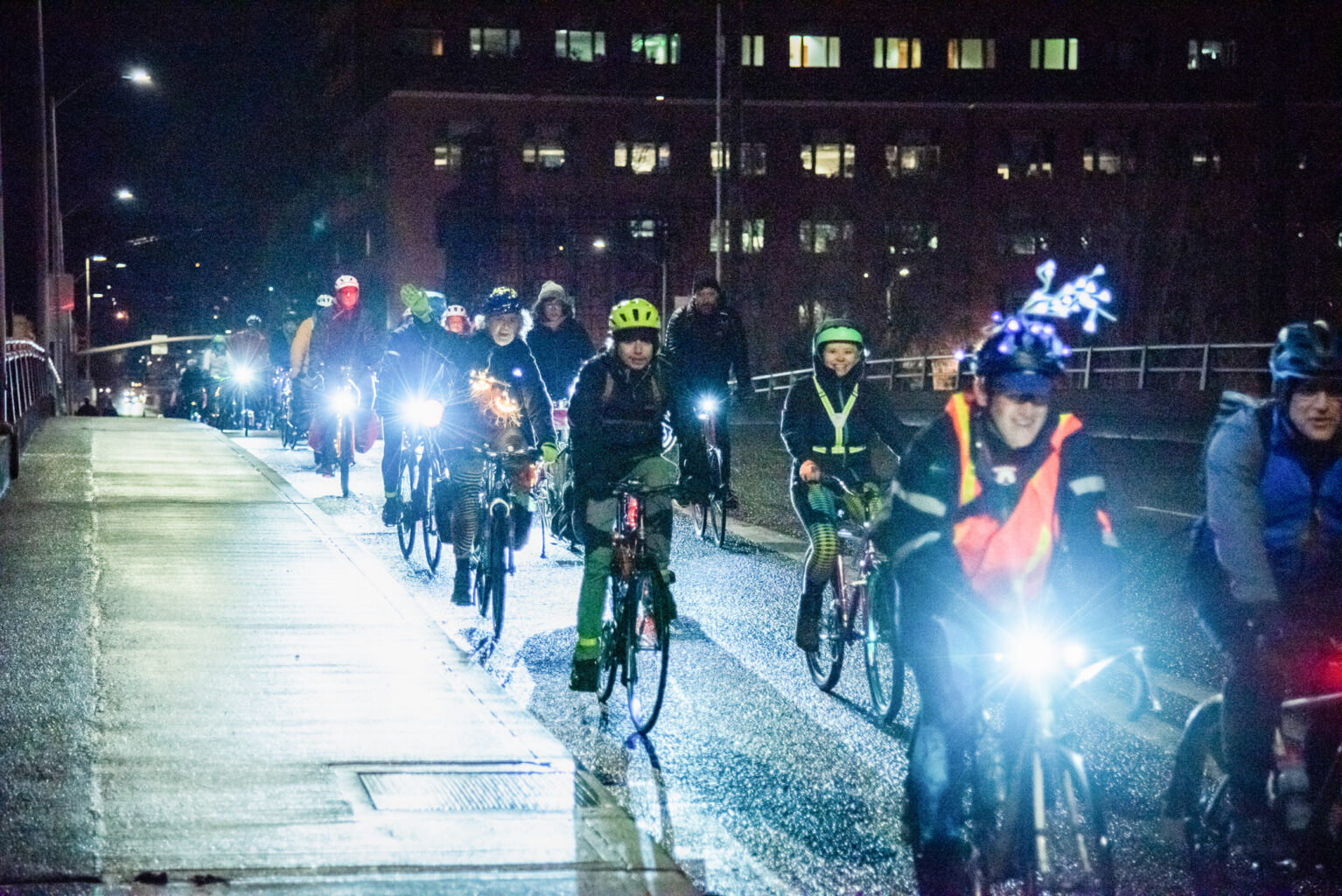 bike commuters at night in winter with headlights glowing
