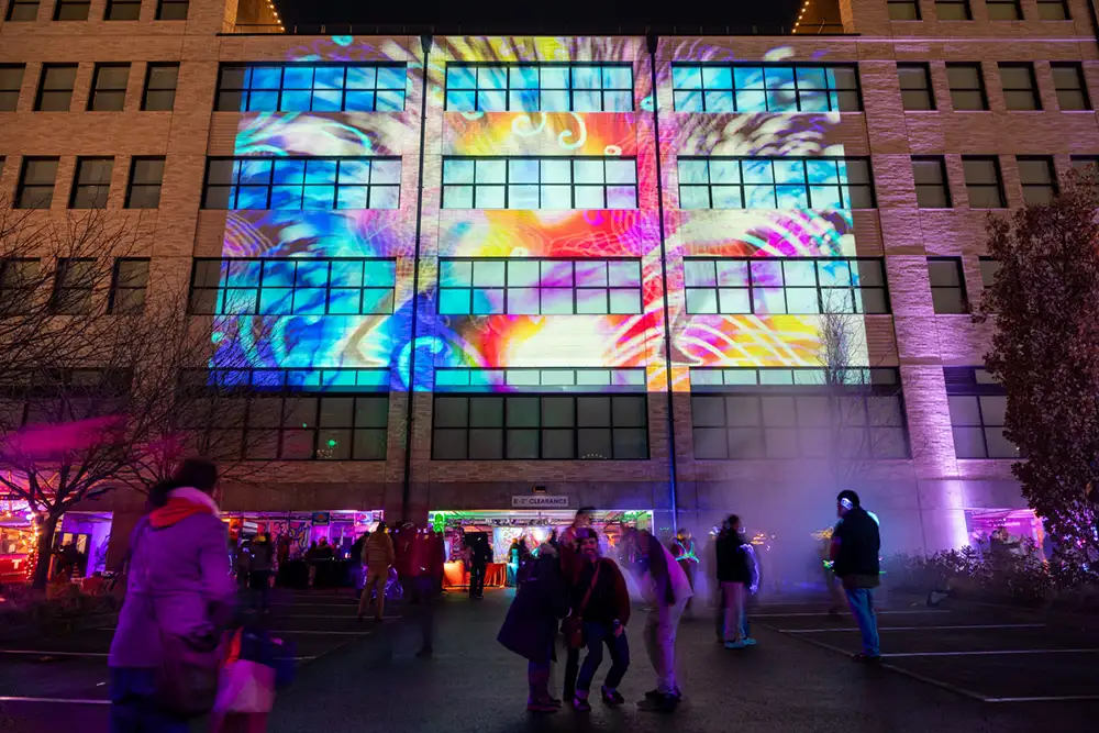projection of colorful graphics on a building at night