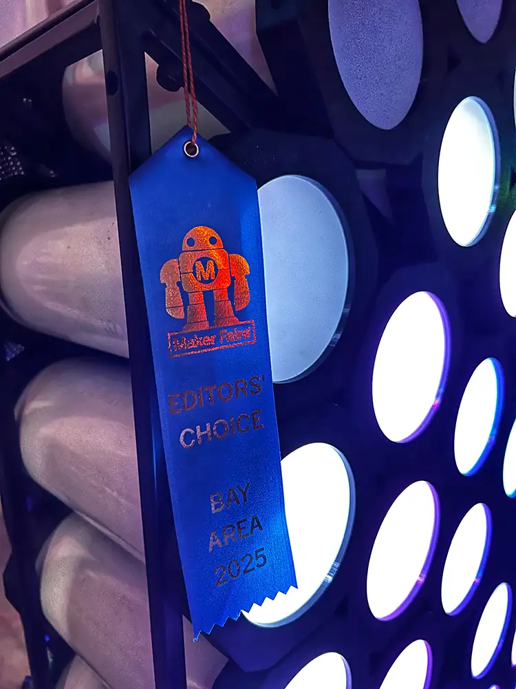Blue ribbon hangs from light-based art installation