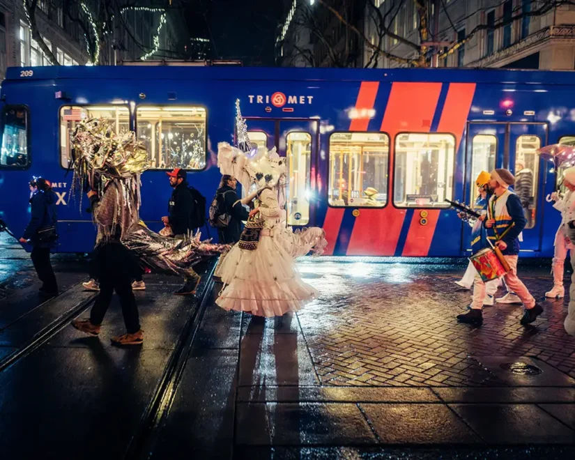 costumed people on a rainy night waiting for public transportation train