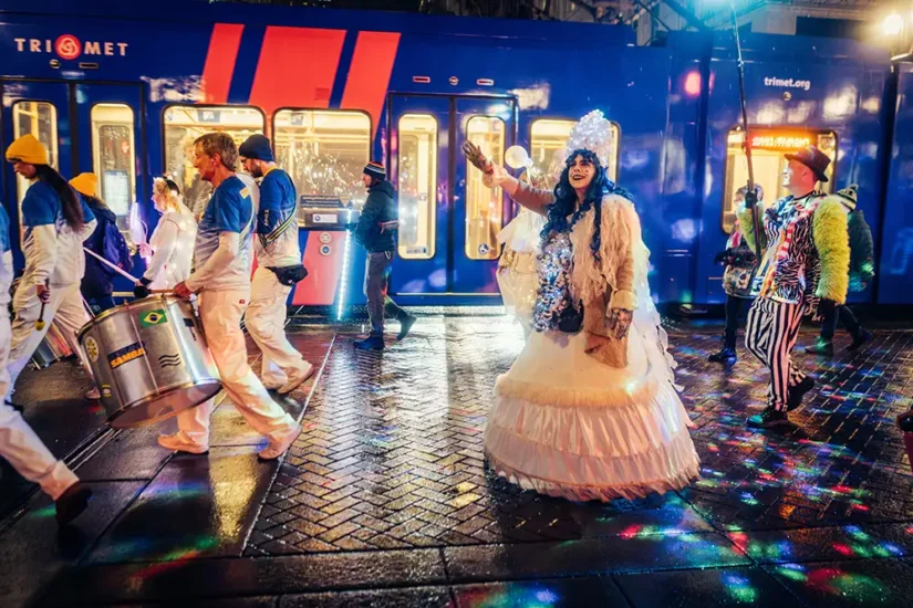 Costumed lady and samba band downtown on a rainy night partying
