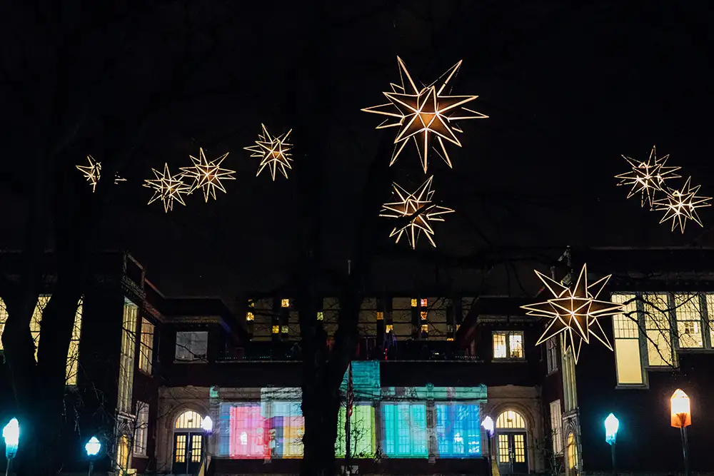 Illuminated stars hang from trees on Portland State University at night