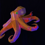 illuminated paper octopus sculpture with glowing pink and orange chromatophores