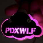 cloud pin illuminated with PDXWLF letters cut out in pink